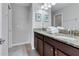 Double vanity bathroom with granite countertops and neutral tones at 1406 Moon Valley Dr, Davenport, FL 33896