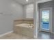 Relaxing bathroom with a large soaking tub and private access at 1406 Moon Valley Dr, Davenport, FL 33896