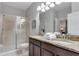Double vanity, granite countertops, and a large walk-in shower at 1406 Moon Valley Dr, Davenport, FL 33896