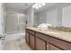 Bathroom with double sinks, granite countertop, and tub at 1406 Moon Valley Dr, Davenport, FL 33896