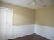 Simple bedroom with ceiling fan, wood-look flooring, and closet at 5595 Deer Creek Dr, Orlando, FL 32821