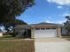 One-story house with attached garage and well-maintained lawn at 5595 Deer Creek Dr, Orlando, FL 32821