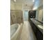 Main bath features double vanity, soaking tub, and shower at 8282 Tavistock Lakes Blvd, Orlando, FL 32827