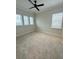 Spacious bedroom with ceiling fan and neutral carpeting at 8282 Tavistock Lakes Blvd, Orlando, FL 32827