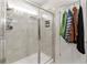 Bathroom with shower, tile surround and storage at 1220 Sugarwood St, Davenport, FL 33837