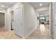 Bright and spacious hallway with tile flooring and access to laundry room at 1220 Sugarwood St, Davenport, FL 33837