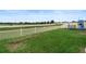 Large grassy backyard with a white picket fence, playset, and trampoline at 1220 Sugarwood St, Davenport, FL 33837