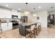 Open kitchen with large island, granite countertops, and modern appliances at 1220 Sugarwood St, Davenport, FL 33837