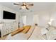 Cozy bedroom with dresser, large TV and warm colored bedding at 1220 Sugarwood St, Davenport, FL 33837