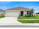 Newly built home with a two-car garage and curb appeal at 1220 Sugarwood St, Davenport, FL 33837