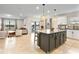Open kitchen with large island, granite countertops, and modern appliances at 1220 Sugarwood St, Davenport, FL 33837