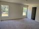 Spacious bedroom with two windows and plush carpeting at 3402 Sw 165Th Loop, Ocala, FL 34473