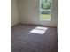 Bright bedroom with carpeted floor, large window, and double door closet at 3402 Sw 165Th Loop, Ocala, FL 34473