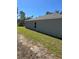 Rear view of the house, showcasing its gray siding and yard at 3402 Sw 165Th Loop, Ocala, FL 34473
