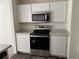 Kitchen with stainless steel appliances and white cabinets at 3402 Sw 165Th Loop, Ocala, FL 34473