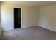 Large bedroom with door to bathroom, featuring wall-to-wall carpet at 3402 Sw 165Th Loop, Ocala, FL 34473
