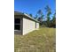 House exterior showcasing the gray siding and backyard at 3402 Sw 165Th Loop, Ocala, FL 34473