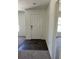 Bright entryway with dark laminate flooring and white door at 3402 Sw 165Th Loop, Ocala, FL 34473