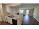 Kitchen with granite countertops and view into living room at 5600 Devonbriar Way # N202, Orlando, FL 32822