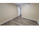 Simple bedroom with wood-look flooring and neutral decor at 5600 Devonbriar Way # N202, Orlando, FL 32822