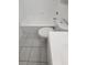 Updated bathroom with white tile and fixtures at 5600 Devonbriar Way # N202, Orlando, FL 32822