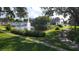 Picturesque pond with bridge, fountain, and lush landscaping at 5600 Devonbriar Way # N202, Orlando, FL 32822
