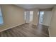 Spacious bedroom with wood-look flooring and closet at 5600 Devonbriar Way # N202, Orlando, FL 32822