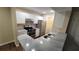 Galley kitchen with stainless steel appliances and granite countertops at 5600 Devonbriar Way # N202, Orlando, FL 32822