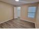 Spacious bedroom with wood-look floors and ample closet space at 5600 Devonbriar Way # N202, Orlando, FL 32822