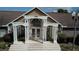 Community building entrance with stairs and landscaping at 5600 Devonbriar Way # N202, Orlando, FL 32822