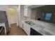 Bright kitchen features double sink, white cabinets, and granite countertops at 5600 Devonbriar Way # N202, Orlando, FL 32822