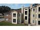 Two-story building with tan and brick exterior at 5600 Devonbriar Way # N202, Orlando, FL 32822