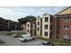 Two-story building with tan and brick exterior at 5600 Devonbriar Way # N202, Orlando, FL 32822