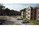Two-story building with tan and brick exterior at 5600 Devonbriar Way # N202, Orlando, FL 32822