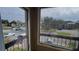 Screened balcony overlooking community parking lot and buildings at 5600 Devonbriar Way # N202, Orlando, FL 32822
