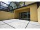 Covered patio with paver stones and sliding glass door at 314 Captiva Dr, Davenport, FL 33896