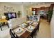 Open concept kitchen and dining area with granite countertops and stainless steel appliances at 314 Captiva Dr, Davenport, FL 33896