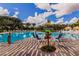 Community pool with lounge chairs and playful signage at 314 Captiva Dr, Davenport, FL 33896