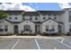 Modern townhome exterior, showcasing a gray facade and well-maintained landscaping at 314 Captiva Dr, Davenport, FL 33896