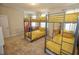 Bedroom with bunk beds and yellow bedding at 314 Captiva Dr, Davenport, FL 33896