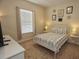 Comfortable bedroom with a queen-size bed and window coverings at 314 Captiva Dr, Davenport, FL 33896