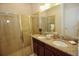Bathroom with double vanity, granite countertop, and shower at 314 Captiva Dr, Davenport, FL 33896