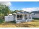 House exterior showcasing a gray painted bungalow at 653 W Thomas St, Lakeland, FL 33805