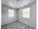 Bright bedroom with two windows and wood-look flooring at 653 W Thomas St, Lakeland, FL 33805