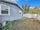 Backyard view of a house with a gray exterior and white fence at 653 W Thomas St, Lakeland, FL 33805
