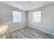 Bright bedroom with two windows and wood-look flooring at 653 W Thomas St, Lakeland, FL 33805