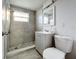 Updated bathroom with gray tile shower, vanity, and toilet at 653 W Thomas St, Lakeland, FL 33805