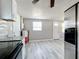 Kitchen area with white cabinets, black appliances, and gray walls at 653 W Thomas St, Lakeland, FL 33805