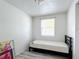 Simple bedroom featuring a twin bed and ample closet space at 653 W Thomas St, Lakeland, FL 33805