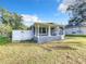 Front view of a cute house with a porch and white fence at 653 W Thomas St, Lakeland, FL 33805